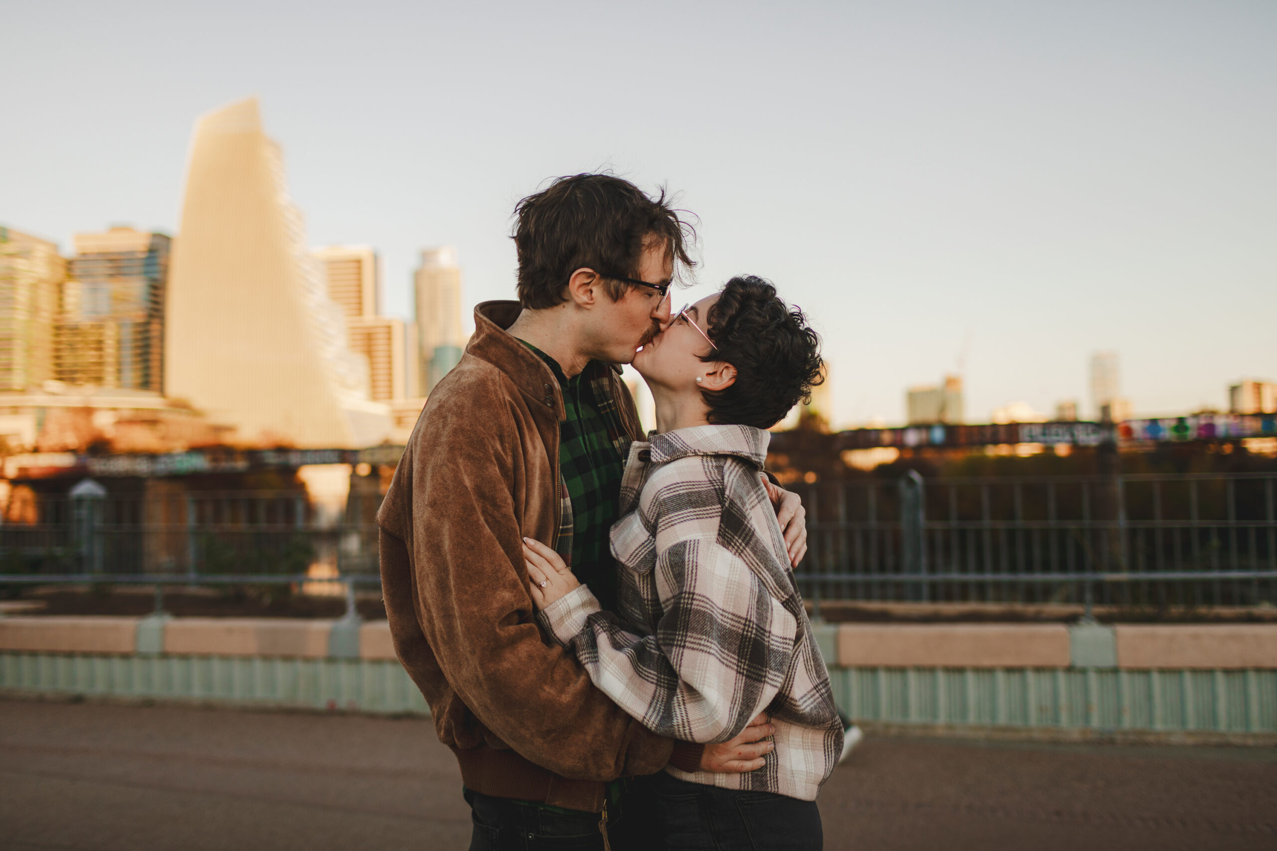 Couple kissing on pedestrian bridge at Zilker Park in Austin, TX
