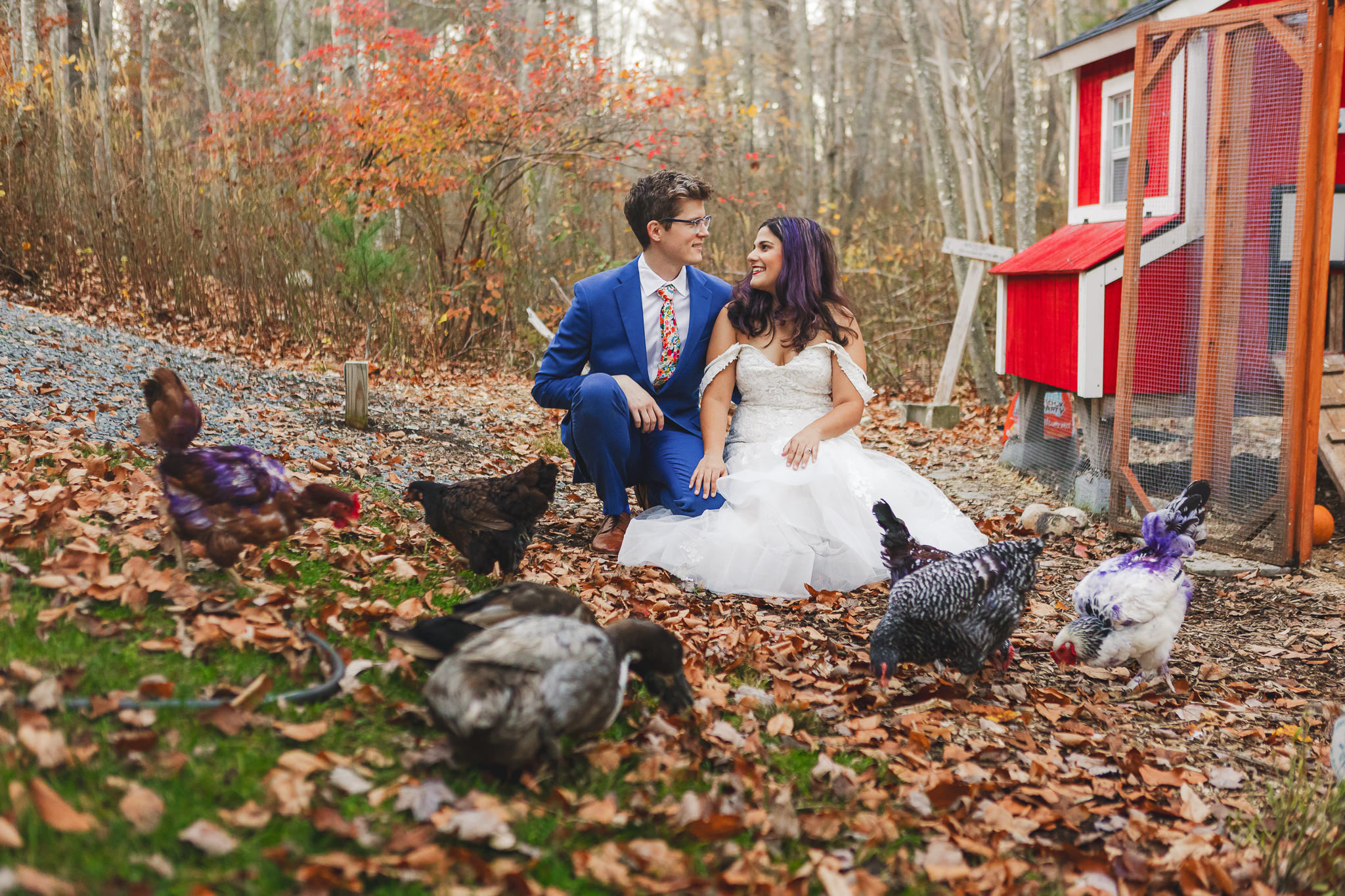 Couple dressed in their wedding attire in backyard with their chickens