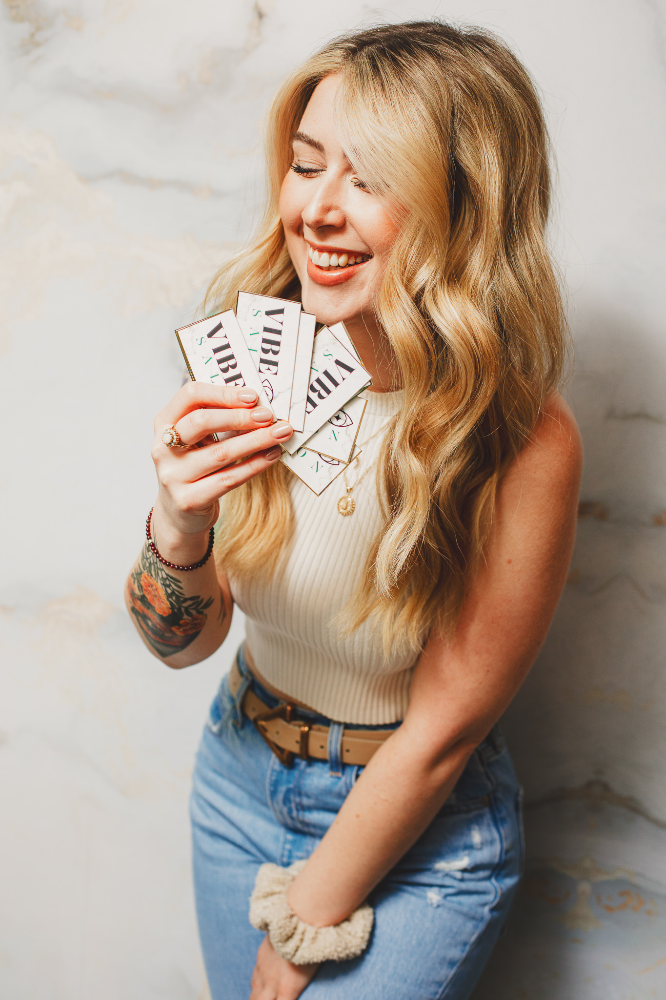 Photo of Jenna, owner of Vibe Salon Studio in Natick holding her business cards during brand photoshoot