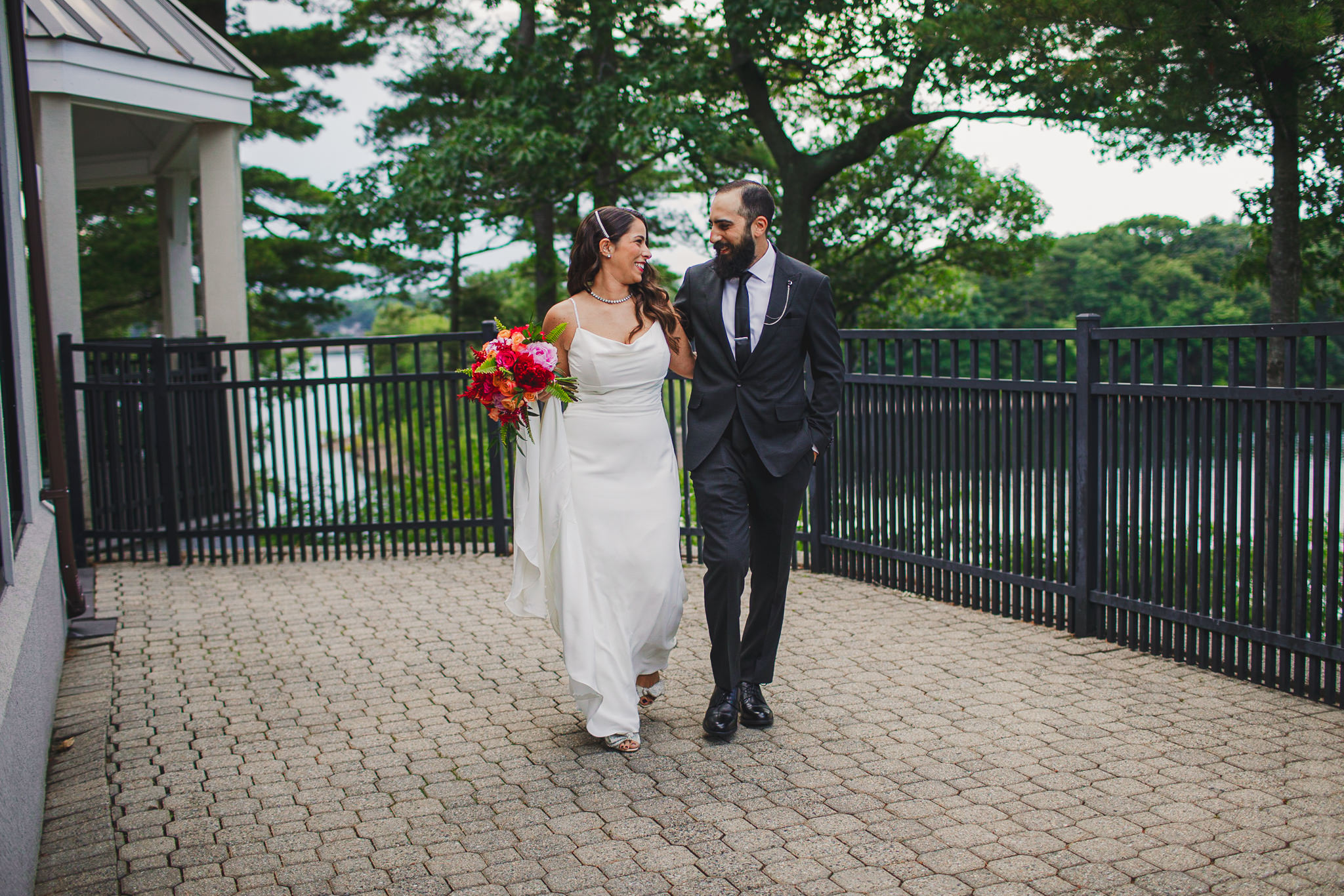 Bride and groom walking together on patio at Spinelli's Lynnfield during wedding reception