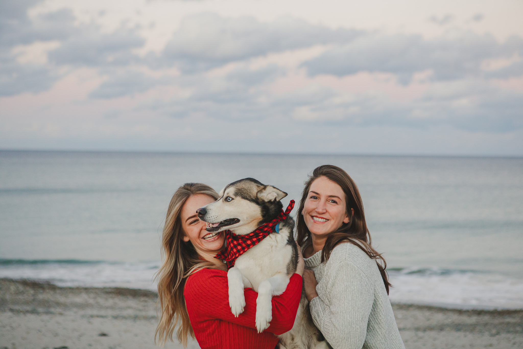 Silly Christmas portraits with two friends and a dog at beach in Marshfield, MA