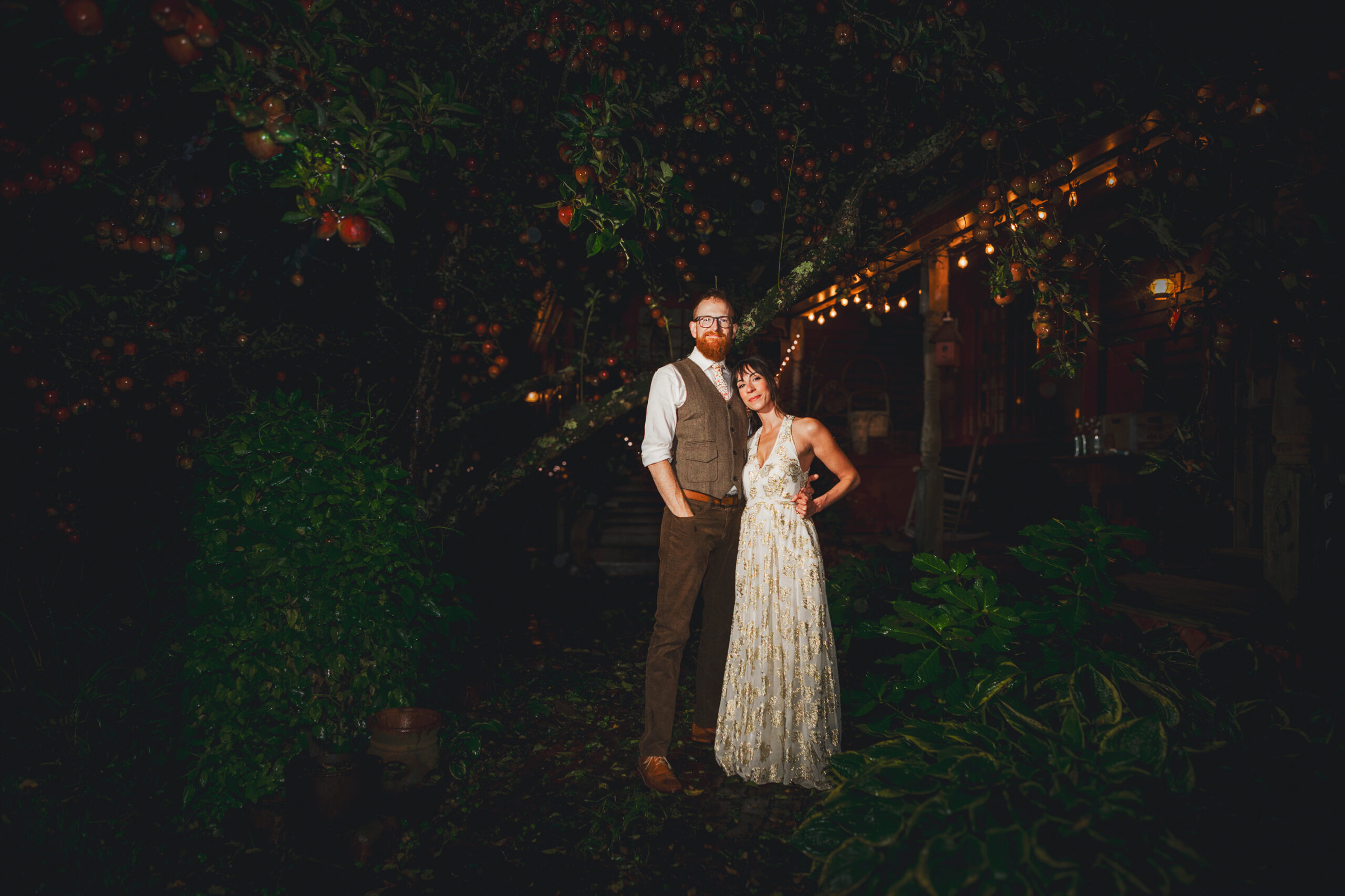 Bride and groom standing outside the barn at Salt River Farm in Marshfield for night portrait