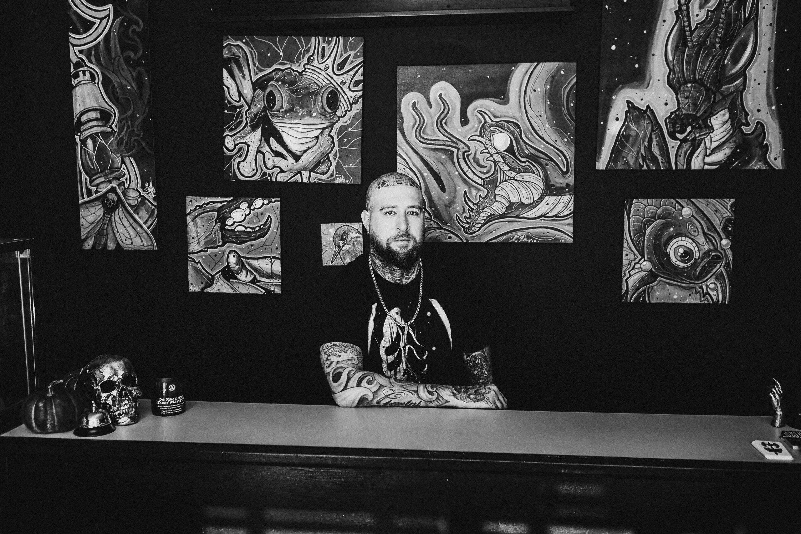 Nick Appromello, owner of Pushin Ink Tattoo Studio in Middleboro, MA posing behind counter for artist portrait